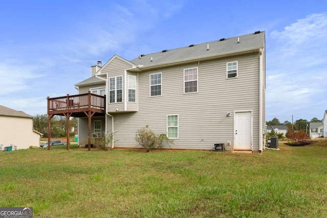 rear view of property featuring a yard, a deck, and cooling unit