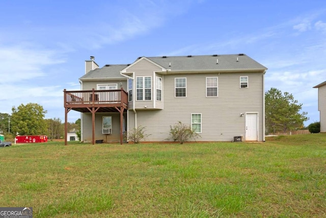 rear view of house with a yard and a deck