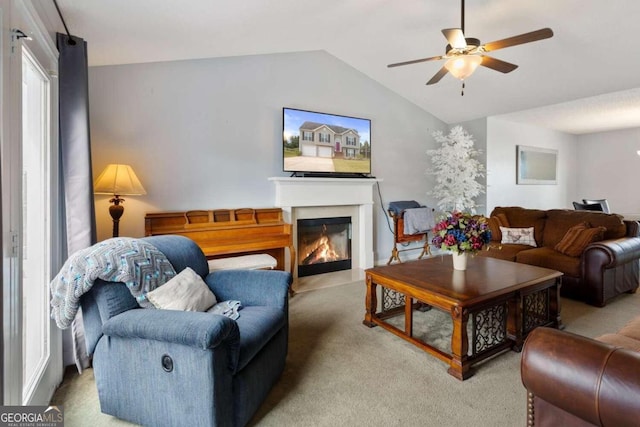 living room with lofted ceiling, carpet, and ceiling fan