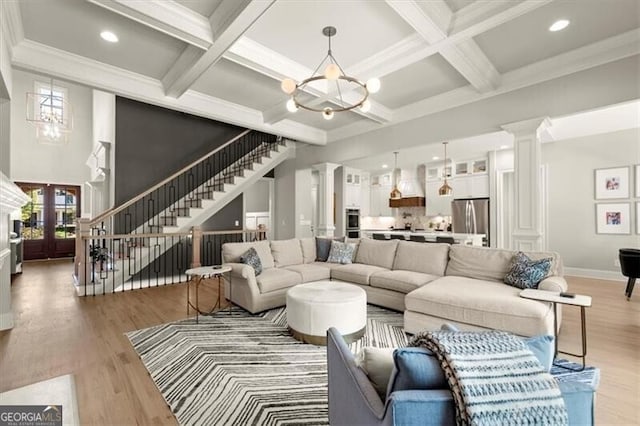 living room featuring coffered ceiling, beamed ceiling, and light wood-type flooring