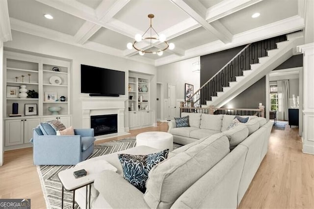 living room with light hardwood / wood-style flooring, beam ceiling, and coffered ceiling