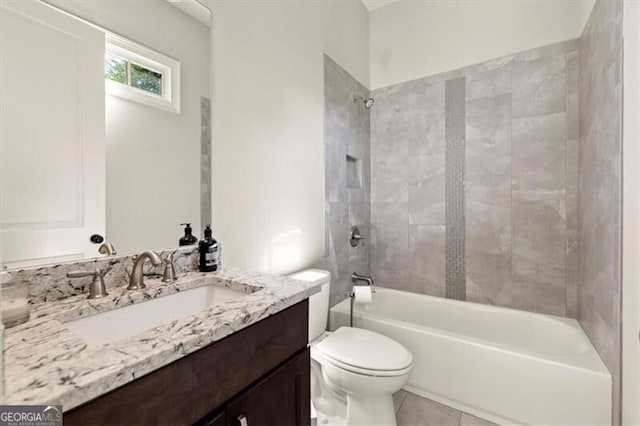 full bathroom with vanity, tiled shower / bath combo, toilet, and tile patterned floors