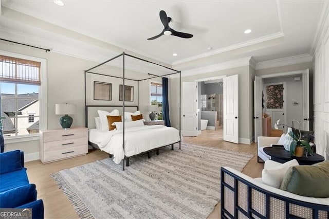 bedroom with connected bathroom, ornamental molding, light wood-type flooring, and ceiling fan