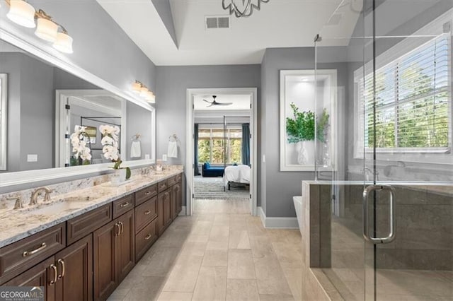 bathroom featuring vanity, tile patterned flooring, plenty of natural light, and a shower with door