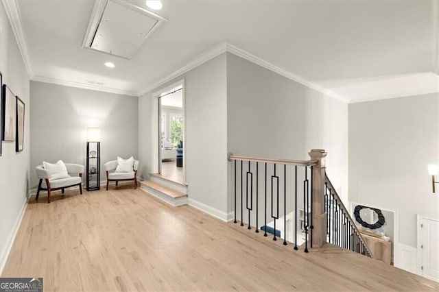 living area featuring light hardwood / wood-style floors and ornamental molding