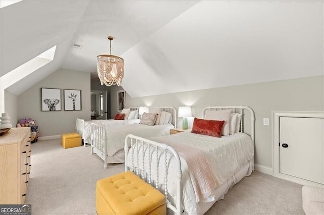 bedroom featuring light carpet, an inviting chandelier, and lofted ceiling with skylight