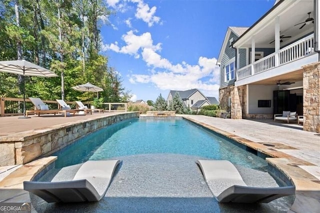 view of pool featuring ceiling fan and a patio area