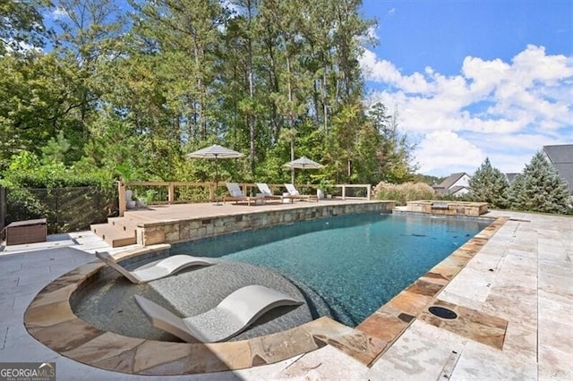 view of pool featuring a patio and a jacuzzi