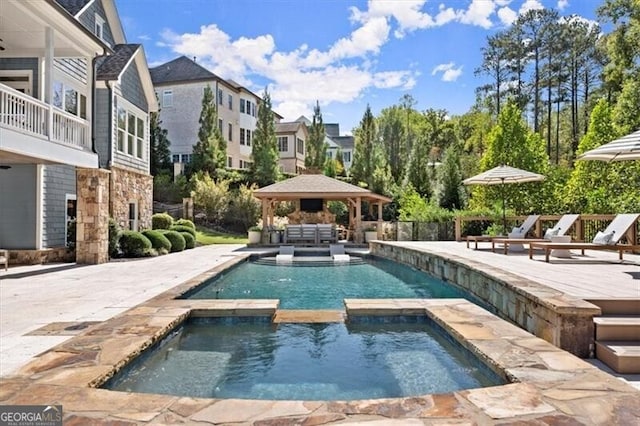 view of swimming pool with a gazebo, an in ground hot tub, and a patio