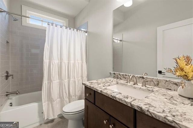 full bathroom with vanity, shower / tub combo, and toilet