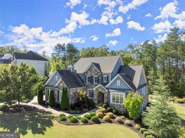 craftsman-style house with a front lawn