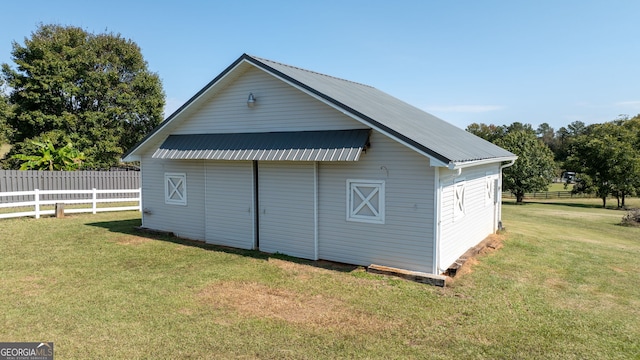 view of outbuilding featuring a yard