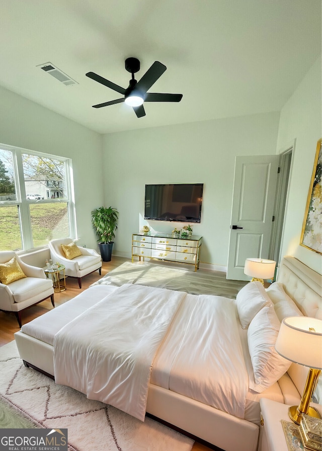 bedroom featuring ceiling fan and light hardwood / wood-style flooring