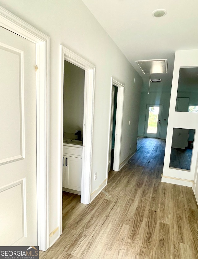 corridor with light wood-type flooring