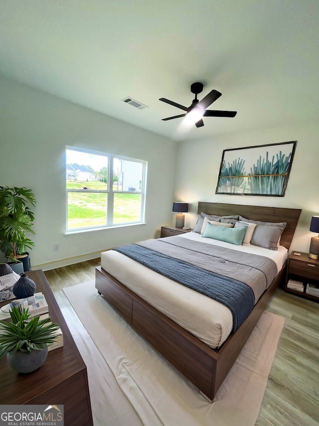 bedroom with ceiling fan and light hardwood / wood-style flooring