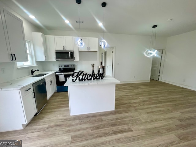 kitchen with pendant lighting, a center island, sink, white cabinetry, and stainless steel appliances