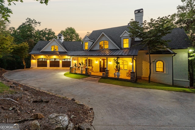 view of front facade with a porch and a garage