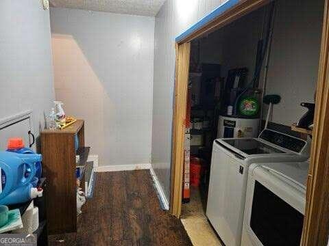 laundry area featuring wood-type flooring and washer and clothes dryer