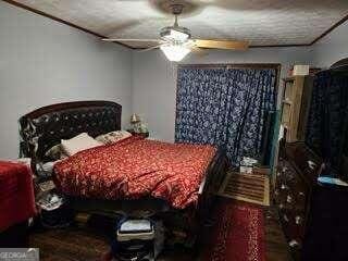 bedroom with a textured ceiling and ceiling fan