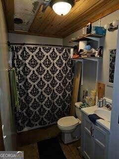 bathroom featuring vanity, wood ceiling, curtained shower, and toilet