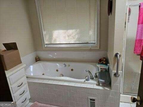 bathroom with tiled tub