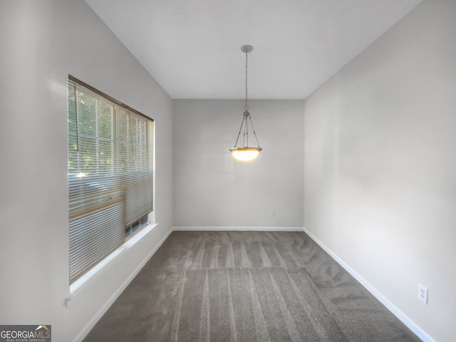 unfurnished dining area featuring carpet flooring