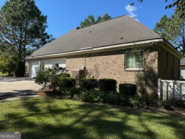 view of home's exterior featuring a yard and a garage