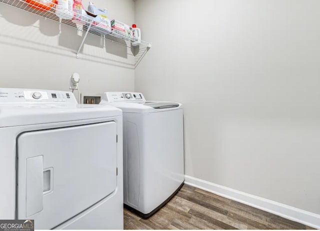 washroom featuring dark hardwood / wood-style flooring and washer and clothes dryer