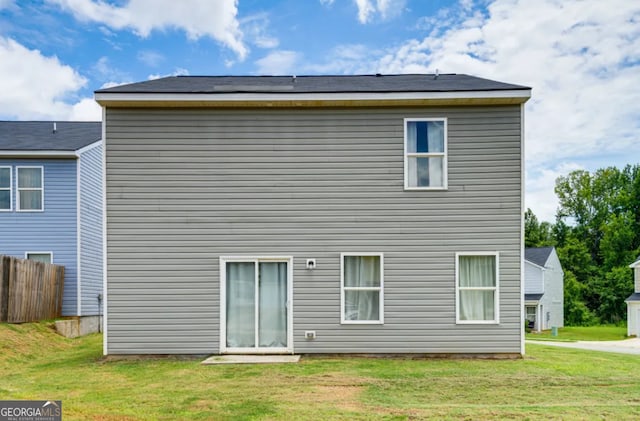 back of house featuring a yard