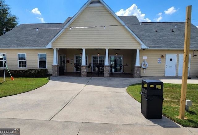 view of front of home with a porch and a front lawn