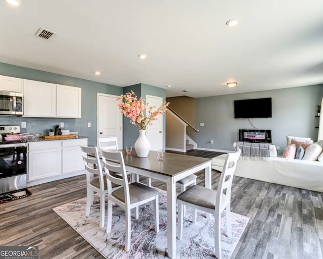 dining area with dark hardwood / wood-style floors