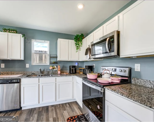 kitchen featuring white cabinets, stainless steel appliances, sink, and dark hardwood / wood-style floors