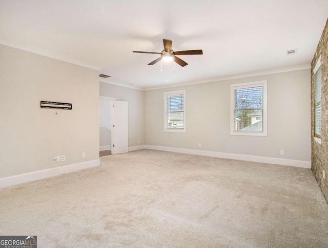 spare room with ornamental molding, light colored carpet, and ceiling fan