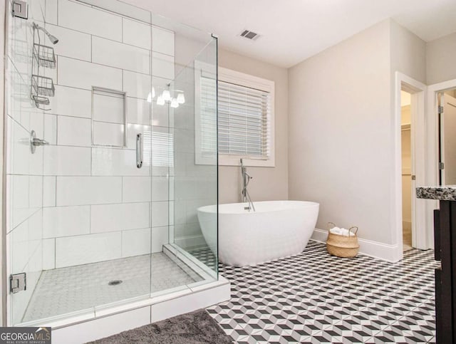 bathroom featuring shower with separate bathtub