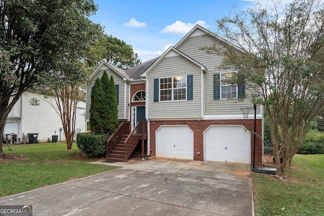 split foyer home with cooling unit, a front lawn, and a garage