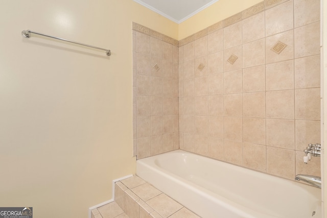 bathroom featuring crown molding and tiled tub