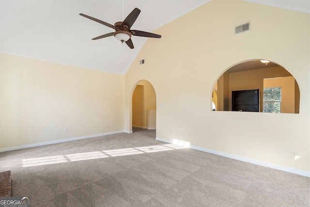 spare room with light carpet, high vaulted ceiling, and ceiling fan