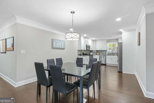 dining area with ornamental molding and dark hardwood / wood-style floors