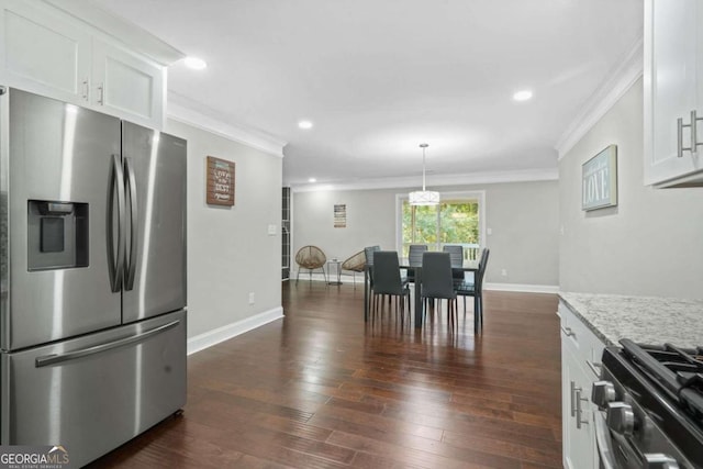 kitchen with ornamental molding, white cabinets, stainless steel appliances, and dark hardwood / wood-style floors