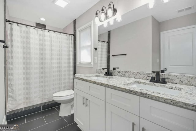 bathroom with vanity, toilet, curtained shower, and tile patterned flooring