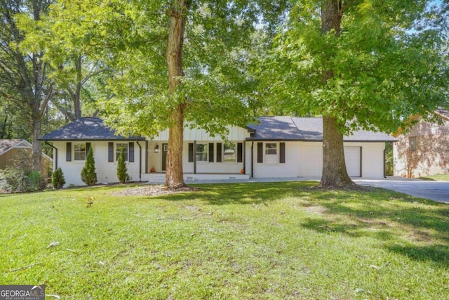 ranch-style home featuring a front yard and a garage