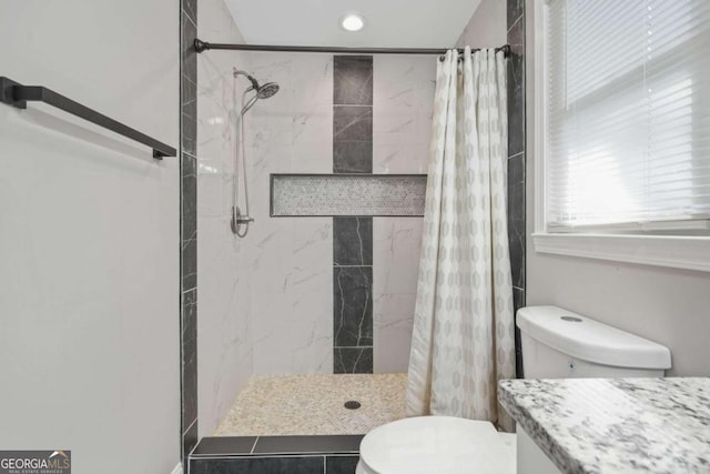 bathroom with toilet and walk in shower