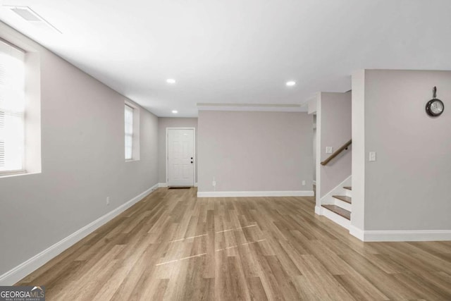 empty room with light hardwood / wood-style flooring and a healthy amount of sunlight