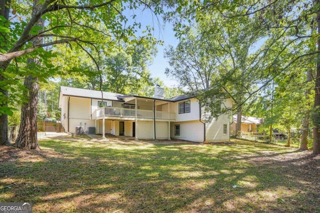 rear view of house featuring a lawn