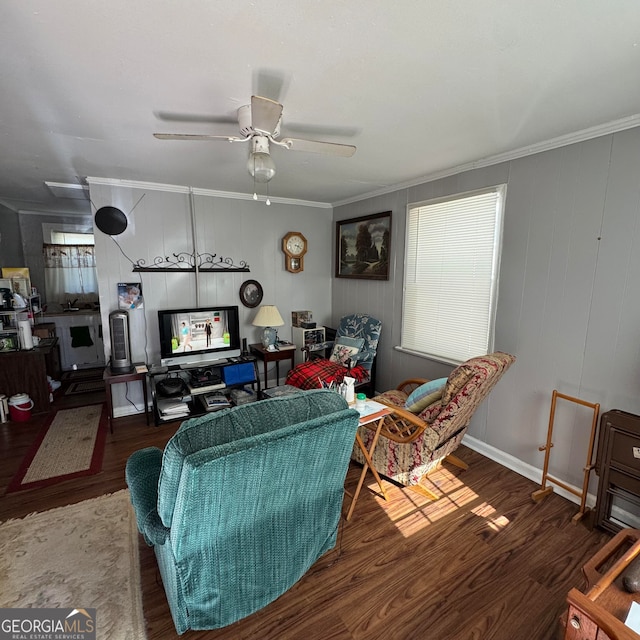 living room with crown molding, dark hardwood / wood-style floors, and ceiling fan