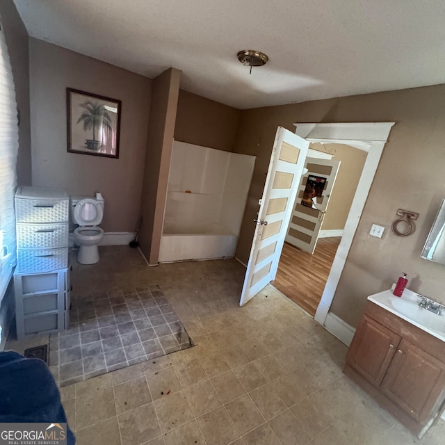 bathroom with vanity, toilet, and hardwood / wood-style floors