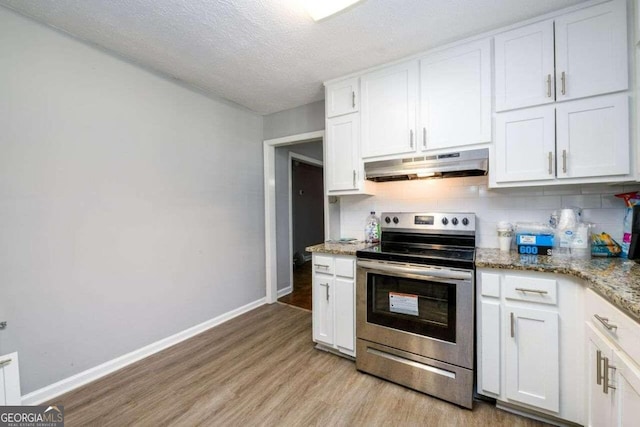 kitchen with light hardwood / wood-style floors, white cabinetry, and electric range