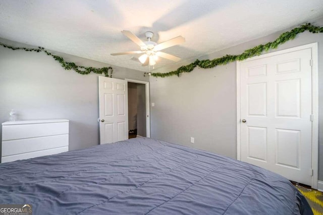 unfurnished bedroom with a textured ceiling and ceiling fan