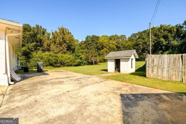 view of yard featuring a storage shed and a patio area