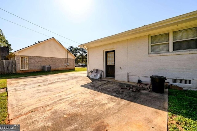 rear view of house featuring central air condition unit and a patio area